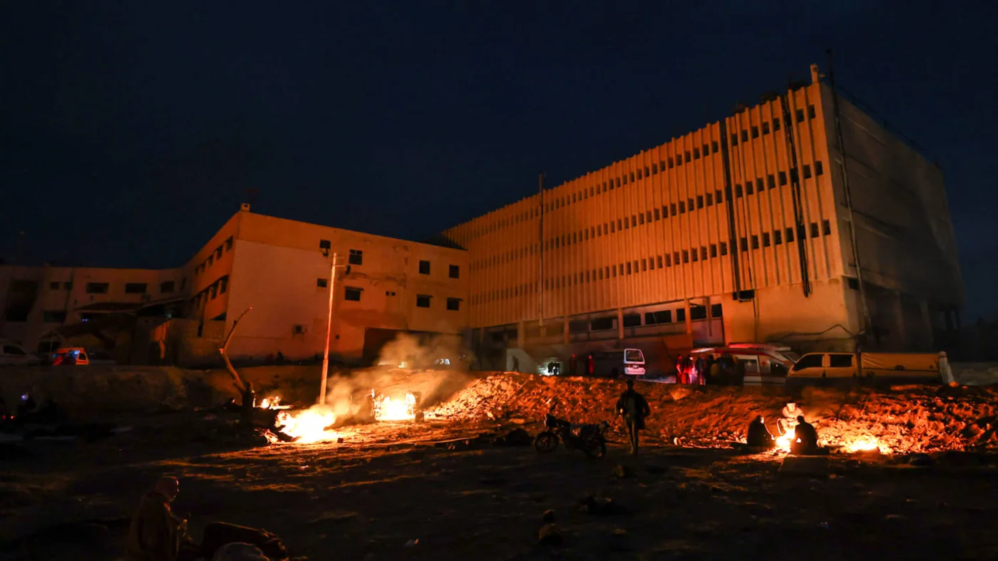 Relatives wait outside the Sednaya prison near Damascus on 11 December 2024 (AFP)