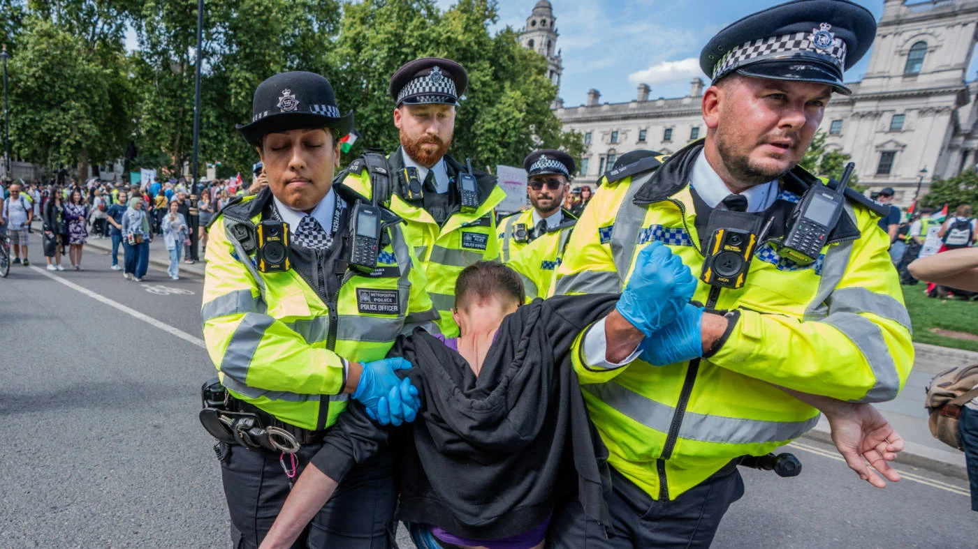 Pro-Palestine supporters are arrested and forcibly moved by police officers towards police vans in Parliament Square, London, on 6 September 2025 (Reuters) 