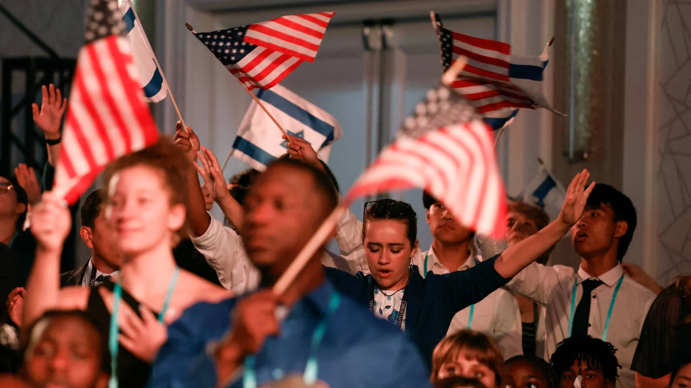 Attendees wave Israeli and US flags at the Christians United for Israel summit in July 2023 in Arlington, Virginia (AFP)