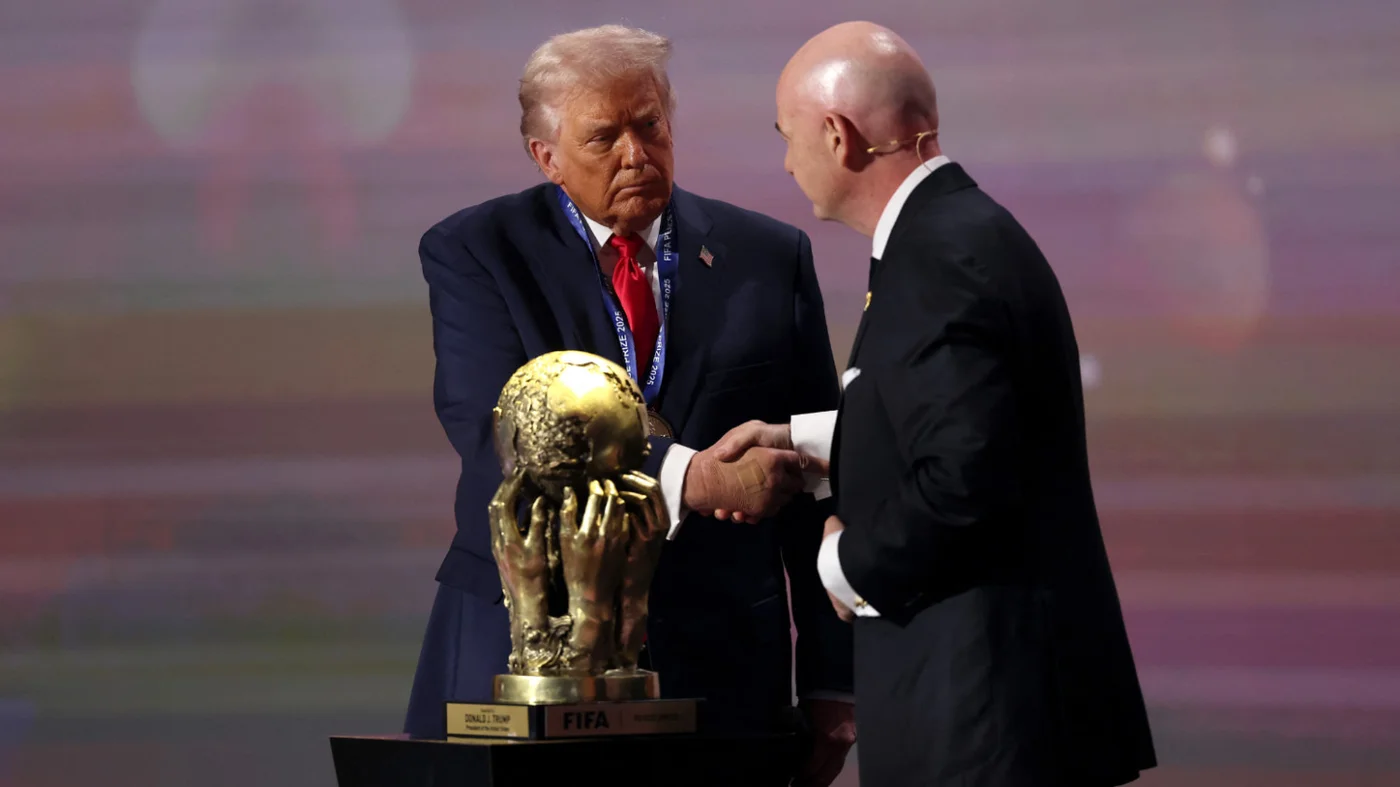 US President Donald Trump receives the FIFA Peace Prize from Gianni Infantino, President of FIFA, at the World Cup Draw in Washington on 5 December 2025 (AFP)