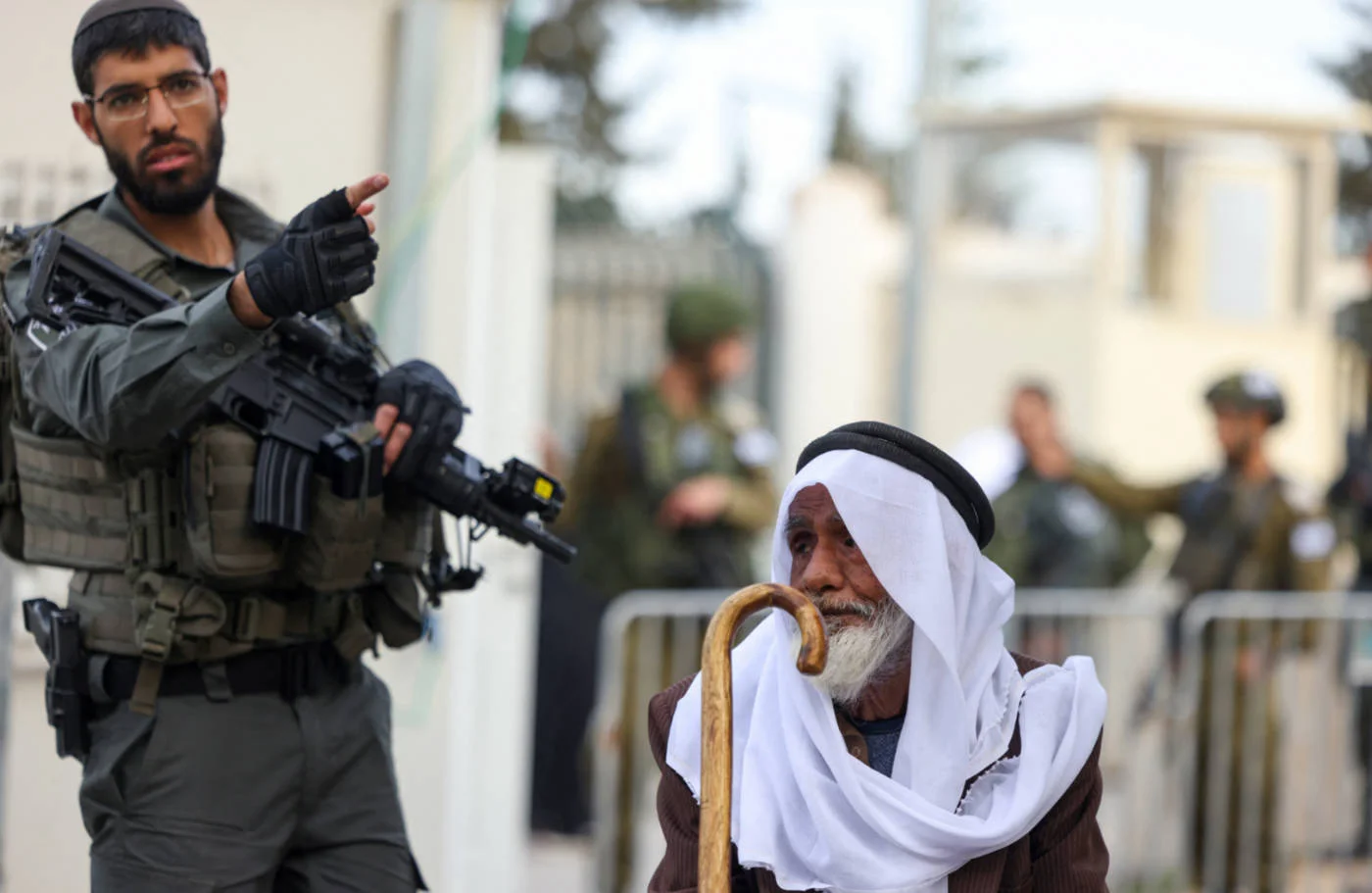 Israeli checkpoints are a daily challenge to life for Palestinians: here, a man in Bethlehem, occupied West Bank, waits to be allowed to go to Al-Aqsa Mosque, east Jerusalem in March 2025 (AFP)
