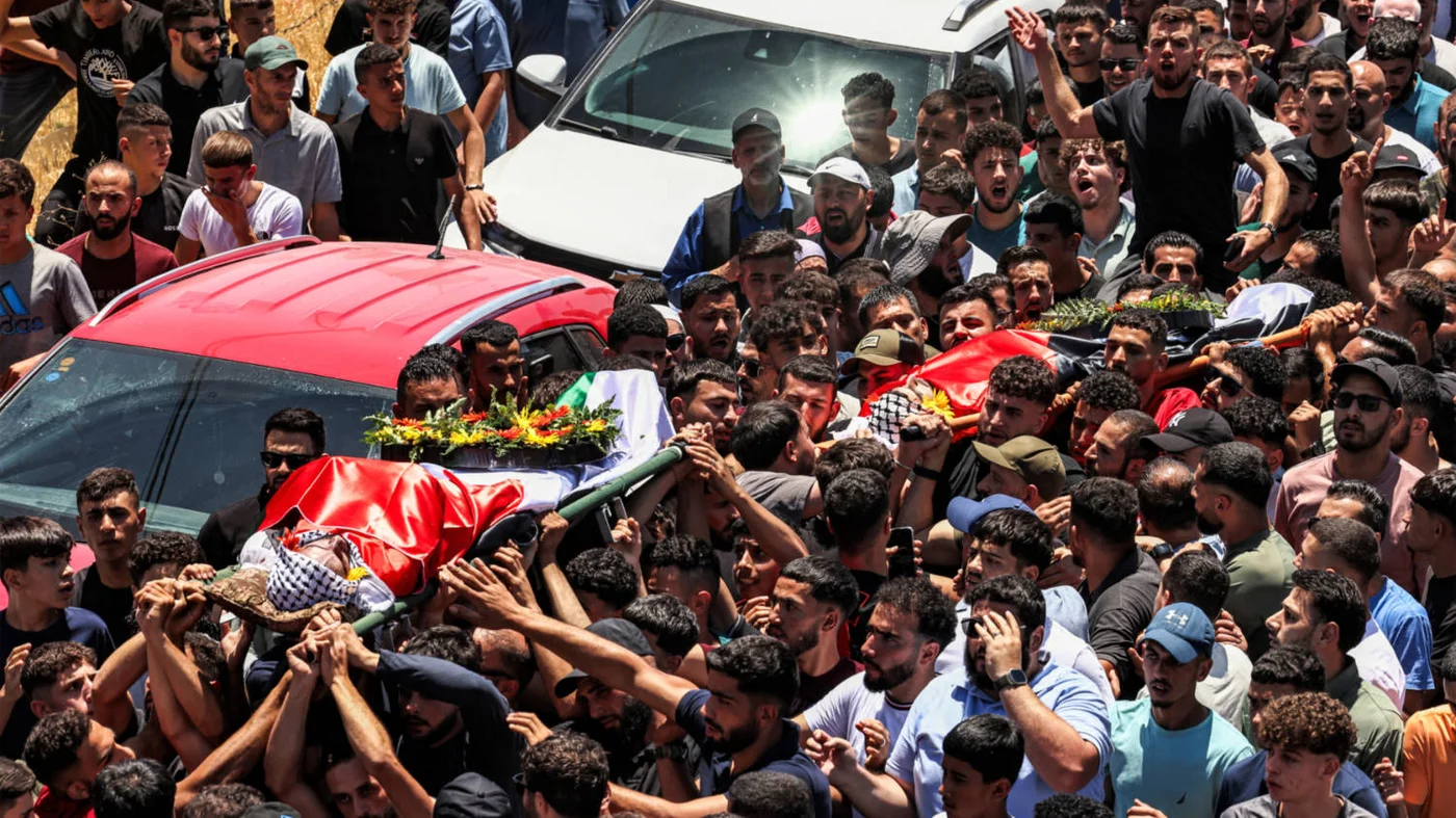 Mourners carry the bodies of dual US-Palestinian citizen Saif al-Din Musalat and Palestinian Muhammad Shalabi in al-Mazraa Al-Sharqiya, murdered by settlers,  in the occupied West Bank on 13 July 2025 (AFP)