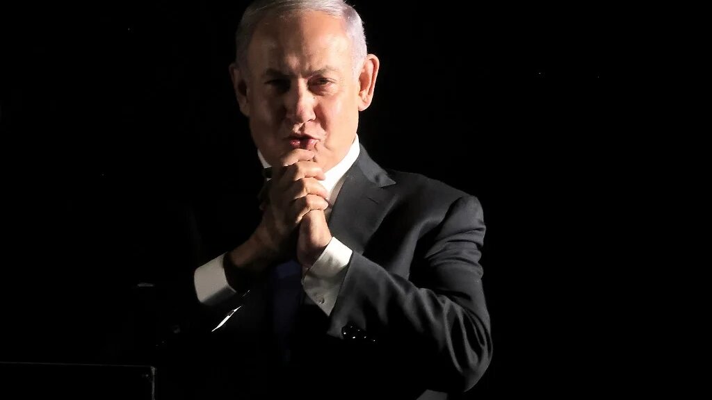 Former Israeli prime minister and current leader of the opposition Benjamin Netanyahu gestures to supporters during an anti-government protest in Jerusalem on 6 April 2022. (AFP)