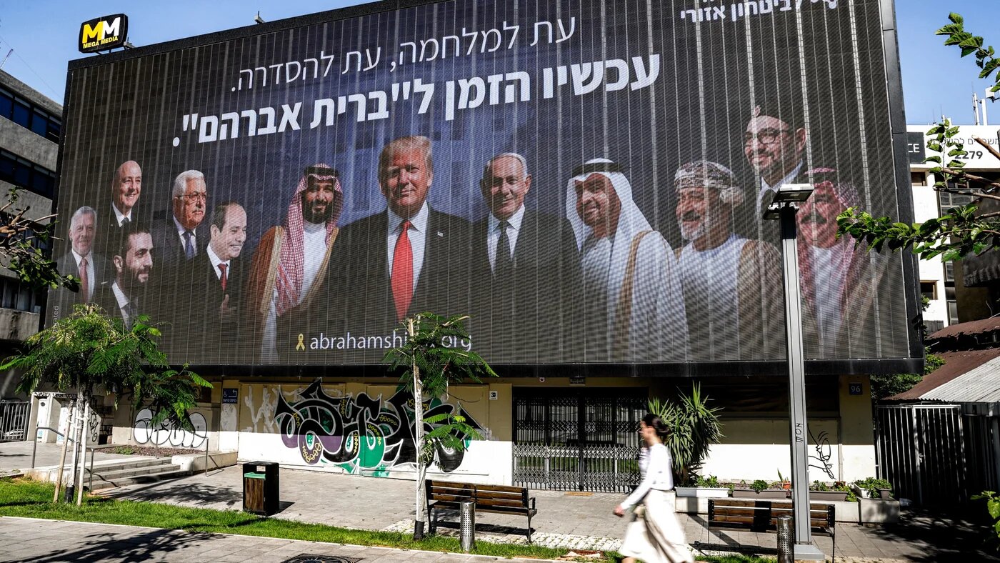 A billboard in Tel Aviv, put up by an Israeli campaign group, depicts Arab leaders alongside Benjamin Netanyahu and Donald Trump under the slogan 'Now is the time for the Abraham Covenant', 26 June 2025 (Jack Guez/AFP)