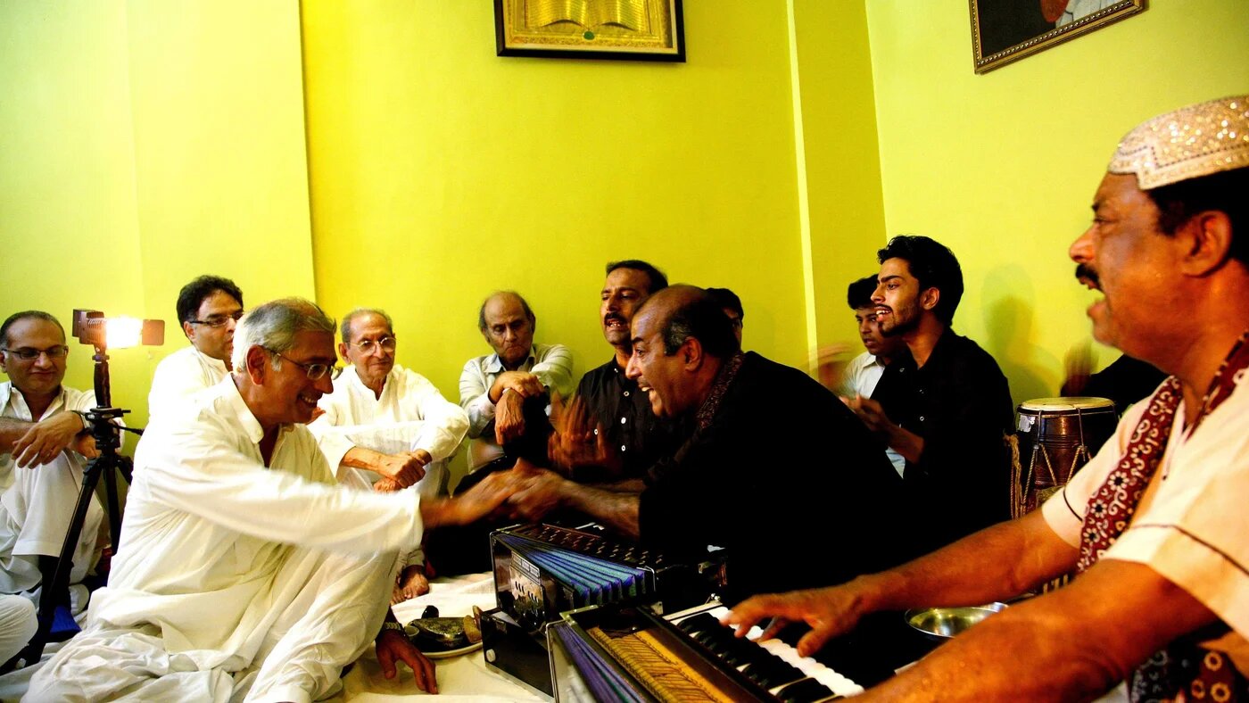 Asif Hasnain and other members of The Dream Journey enjoy a qawwali performance by Ustads Fareed Ayaz and Abu Muhammad.