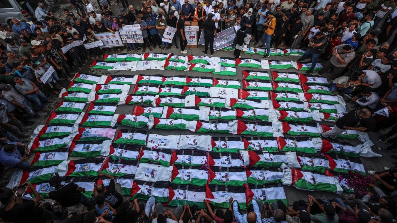 Mourners gather for a mass burial of around 100 Palestinians, including 62 children, whose remains were recovered from rubble, in Gaza City, on 6 September 2026 (Omar al-Qattaa/AFP)