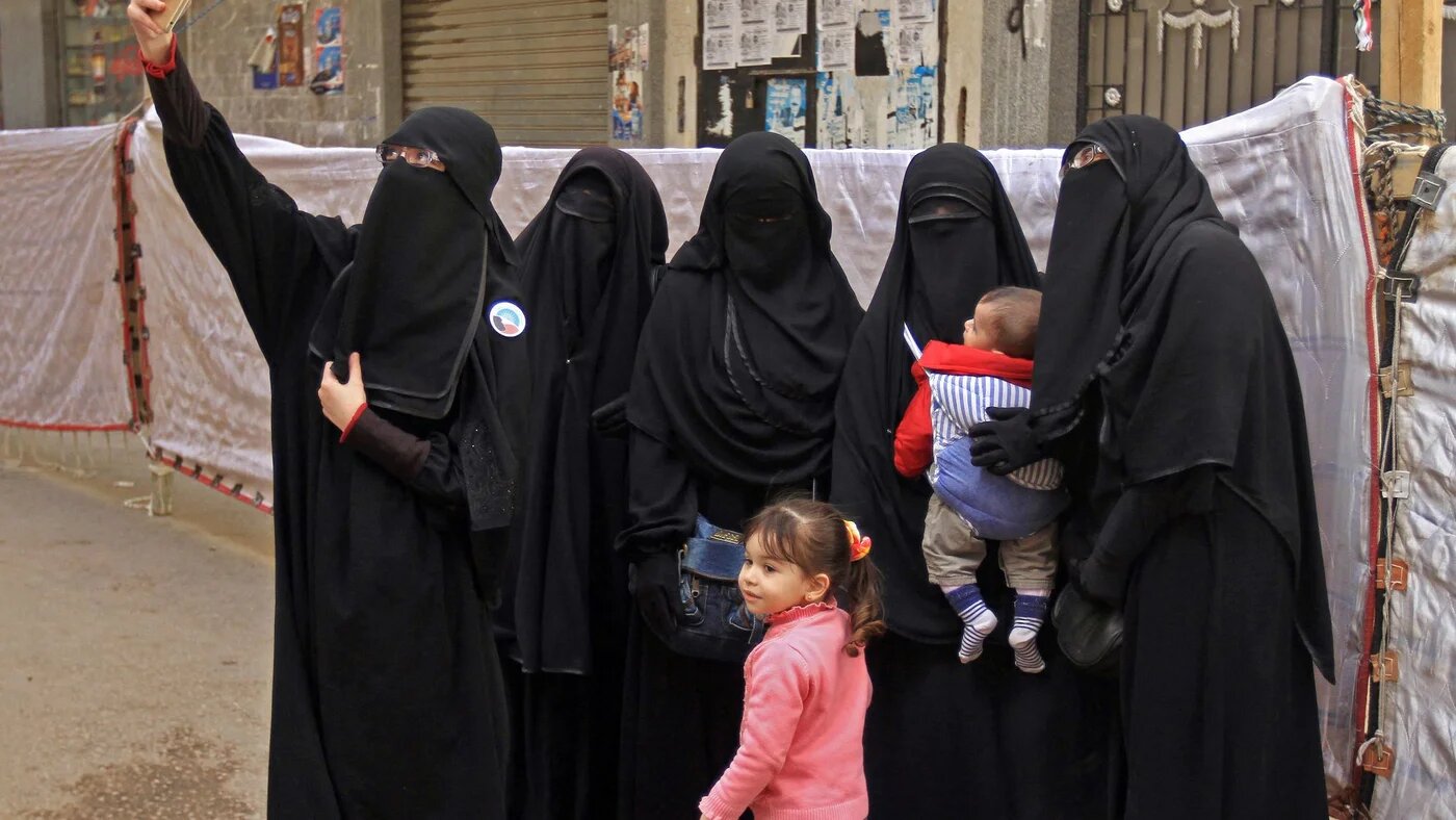 Egyptian women wearing niqabs pose for a photograph outside a polling station in Alexandria in 2018