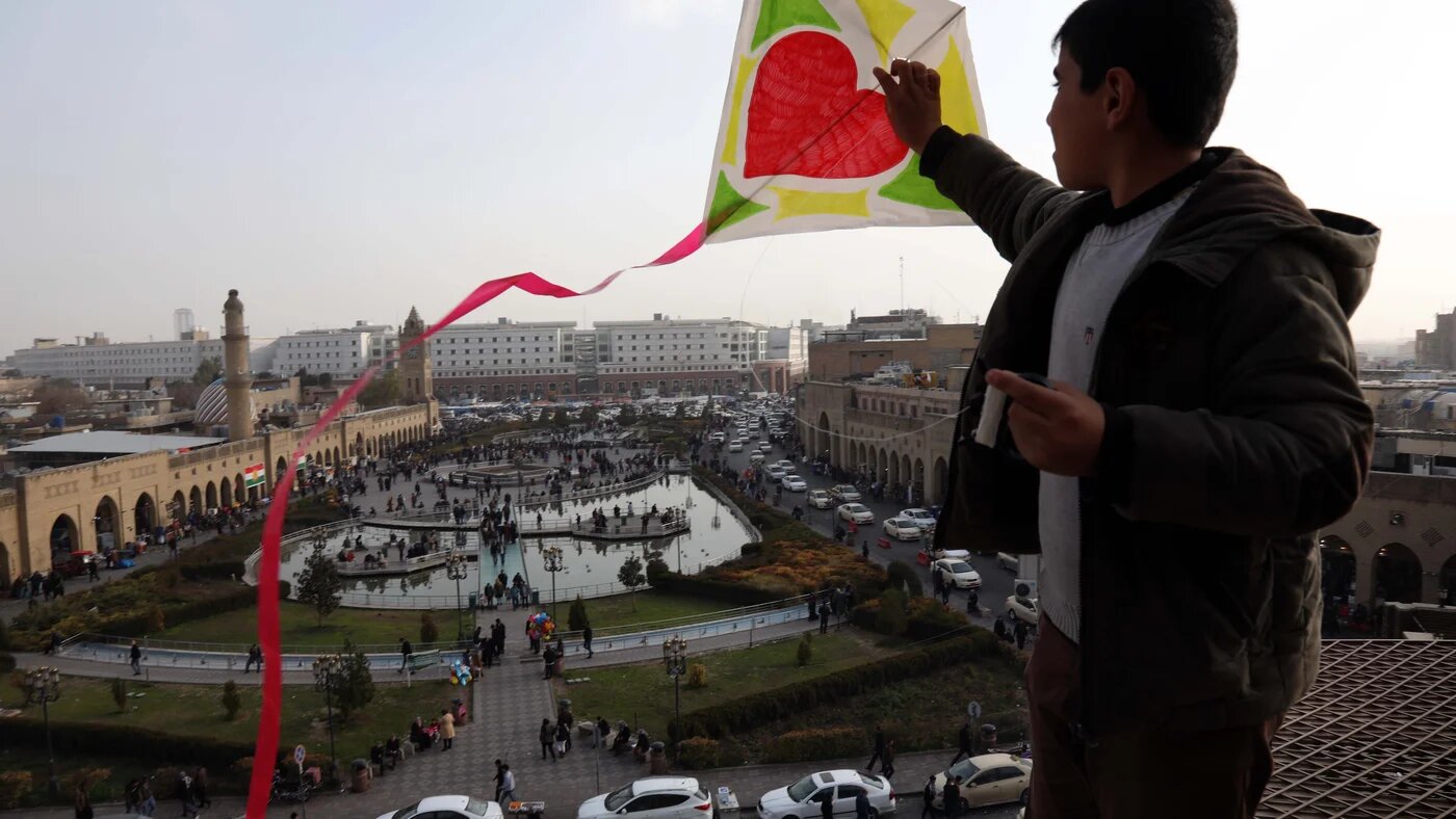 An Iraqi Kurdish child flies a kite in the central square of Erbil