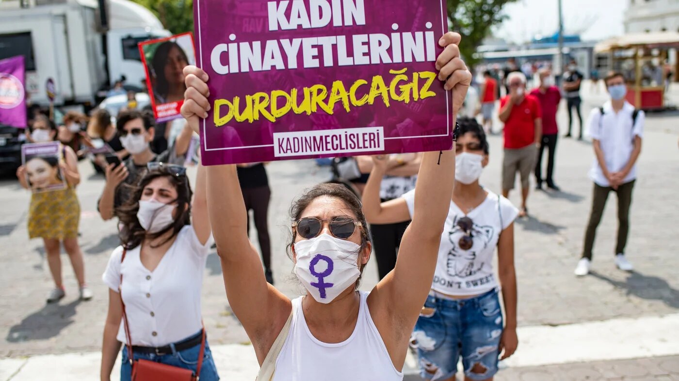 A demonstrator wearing a protective face mask, holds a placard reading 'stop femicides' during a protest called by KCDP (We Will Stop Femicides Platform - Kadin Cinayetlerini Durduracagiz Platformu) and Women’s Assemblies, for a better implementation of the Istanbul Convention and the Turkish Law 6284 for protection of the family and prevention of violence against women, in Istanbul, Turkey (AFP)