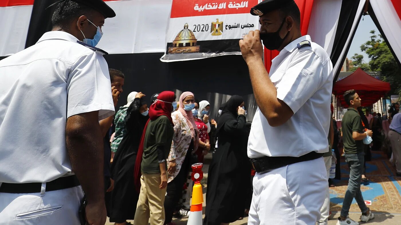 Egyptians queue up outside a polling station on August 11, 2020