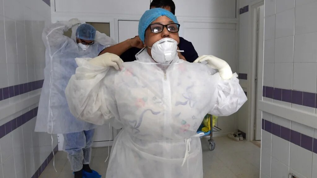 Des médecins d’une unité de soins intensifs à l’hôpital de Gabès, au sud-ouest de la Tunisie, se préparent alors que la région connaît un pic de contaminations, le 26 août 2020 (AFP)