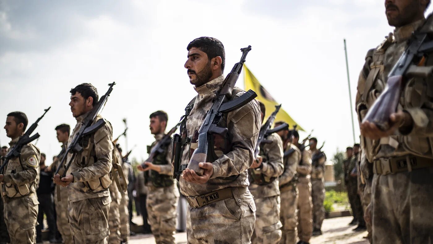 Members of the Kurdish-led Syrian Democratic Forces (SDF) attend the funeral of a fellow fighter in Qamishli, Syria