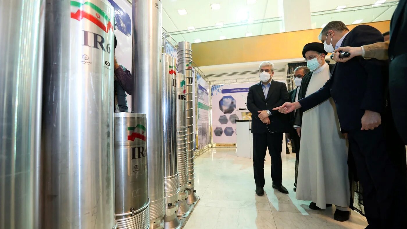 Iran's President Ebrahim Raisi (2-R) and Atomic Energy Organisation of Iran chief Mohammad Eslami (R) at a 'Nuclear Technology Day' event in Tehran, 9 April 2022 (AFP)