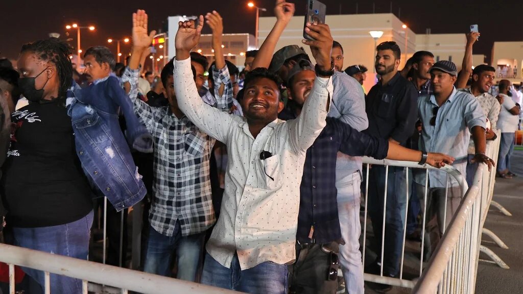Migrant workers attend an event marking 200 days to go until the 2022 FIFA World Cup, in the Qatari capital Doha on 6 May 2022 (AFP)