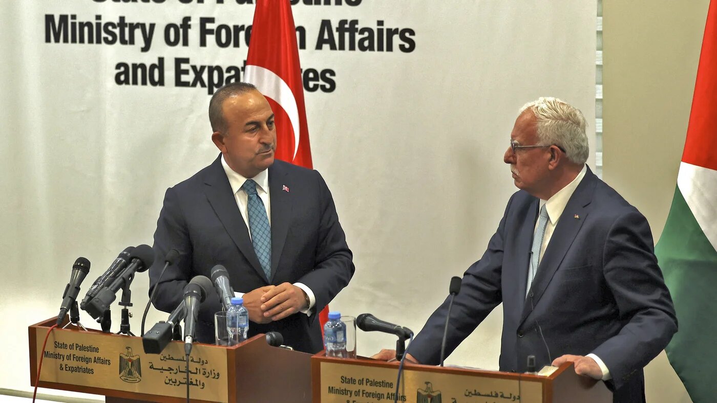 Palestinian Foreign Minister Riyad al-Maliki (R) and Turkish Foreign Minister Mevlut Cavusoglu attend a press conference after meeting in the city of Ramallah in the occupied West Bank on 24 May 2022 (AFP)