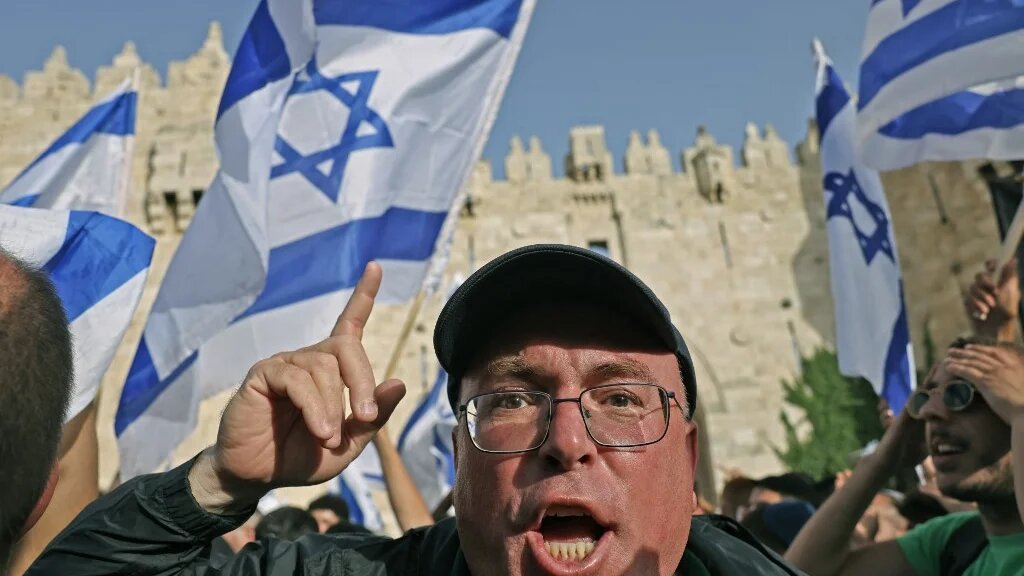 A demonstrator gestures during the far-right Israeli 'flags march' to mark "Jerusalem Day" outside the old city's Damascus Gate on 29 May 2022. (AFP)