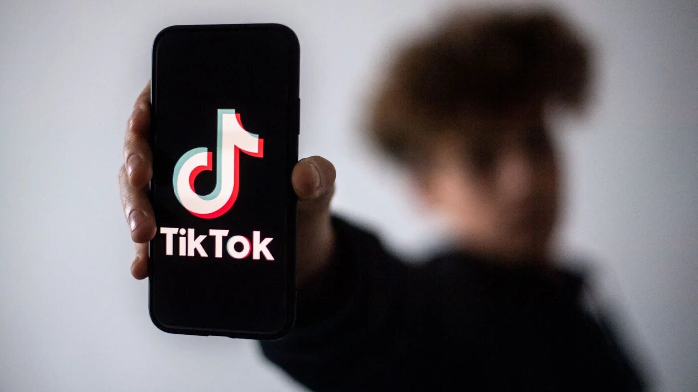 In this file photo taken on January 21, 2021 a teenager presents a smartphone with the logo of Chinese social network Tik Tok in Nantes, western France (AFP)