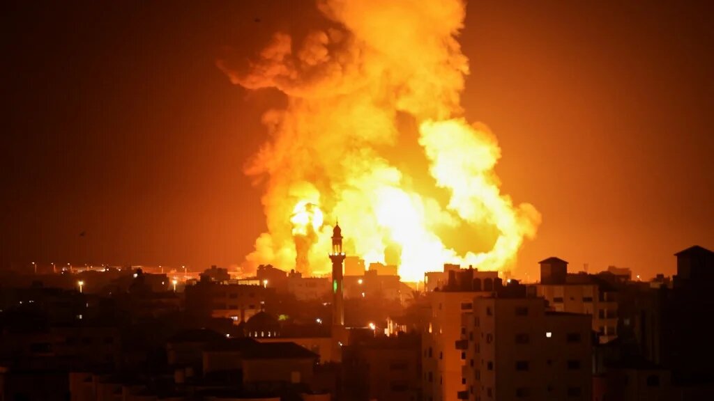 Fires are seen following an Israeli air strike in Gaza city on 16 July 2022 (AFP)
