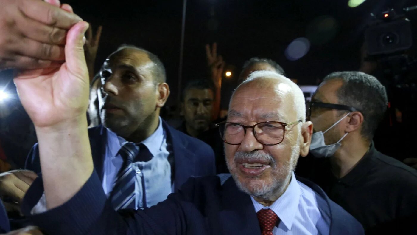 Rachid Ghannouchi, head of Tunisia's Islamist Ennahda party, greets his supporters as he leaves the office of Tunisia's counter-terrorism prosecutor in Tunis on July 19, 2022 (AFP)