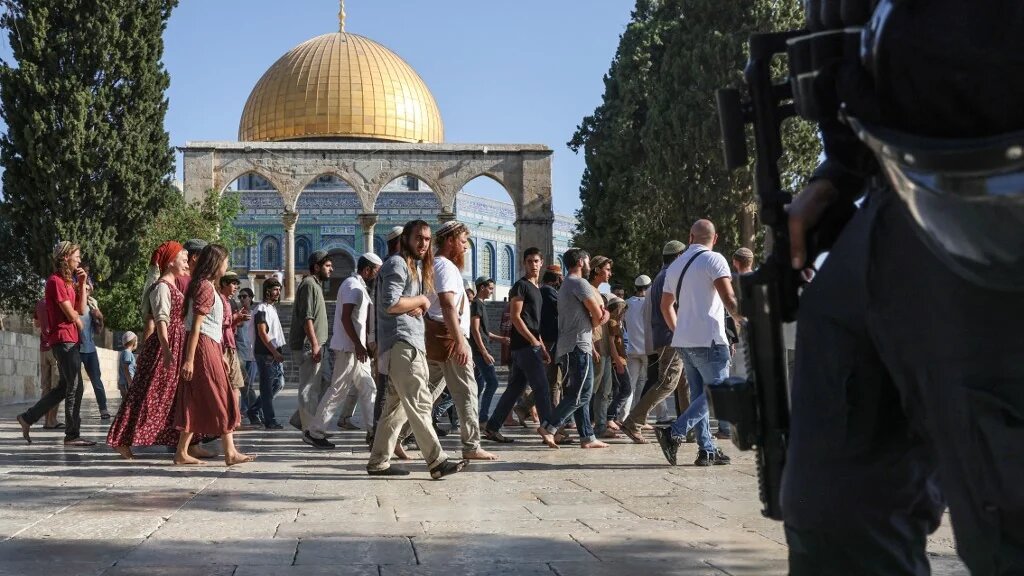 Israeli forces protect Israeli settlers storming al-Aqsa Mosque on 7 August 2022 (AFP)