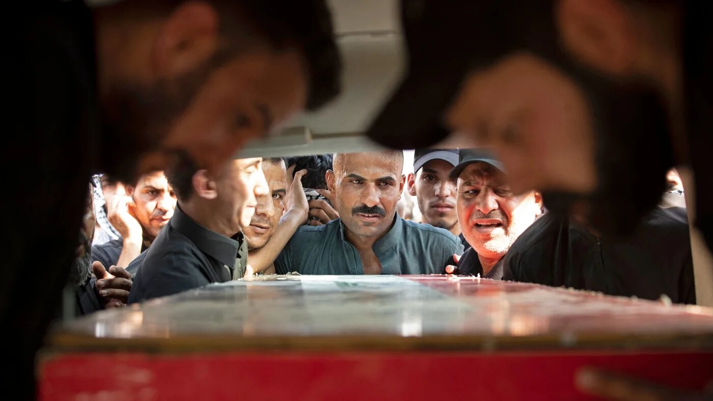 Mourners attend the funeral of two Saraya al-Salam fighters in Basra on 1 September (AFP)