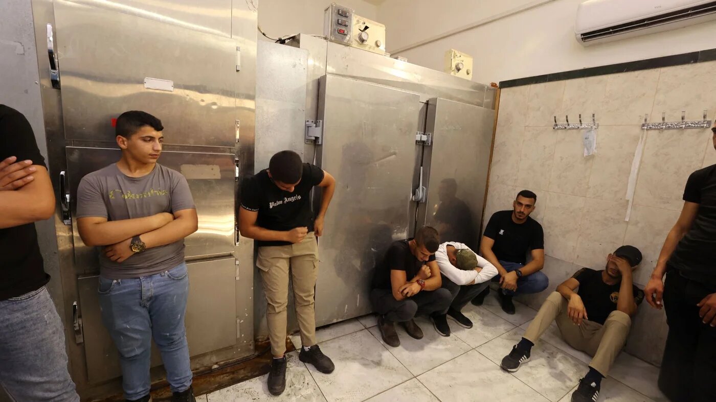 Friends and relatives mourn the death of Palestinian Uday Salah, 17, killed by Israeli forces, at the Jenin hospital morgue, in the occupied West Bank, on 15 September 2022 (AFP)