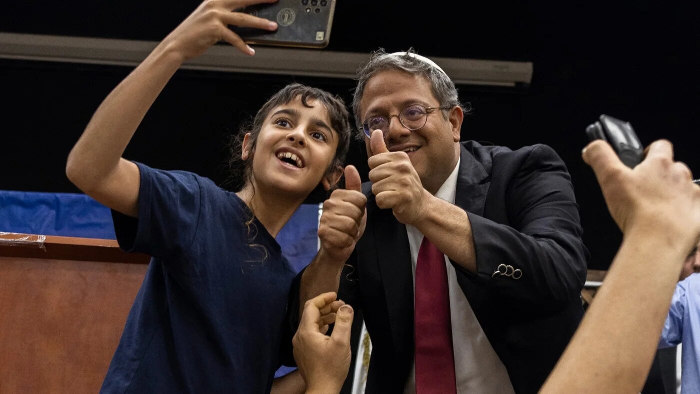 Itamar Ben-Gvir is greeted by his supporters during a campaign rally in the southern Israeli city of Ashkelon on 25 October (AFP)