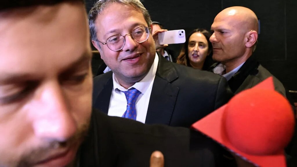 Leader of Israel's Jewish Power far-right party Itamar Ben Gvir speaks with supporters as he arrives to a hotel in Jerusalem before national election polls close on 1 November 2022 (AFP)