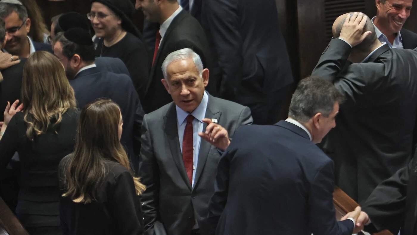 Israeli prime minister-designate Benjamin Netanyahu (C) attends a session to elect the new speaker of the Knesset (Israeli parliament) at its Plenum Hall in Jerusalem on December 13, 2022 (AFP)