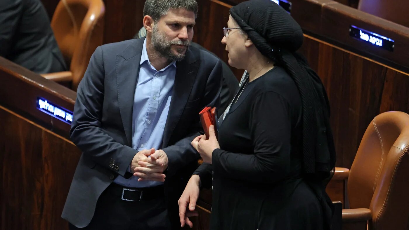 Israeli Knesset member Bezalel Smotrich (L) speaks with Orit Strook (R) during a session elect the new speaker of the assembly in Jerusalem on 13 December 2022 (AFP)