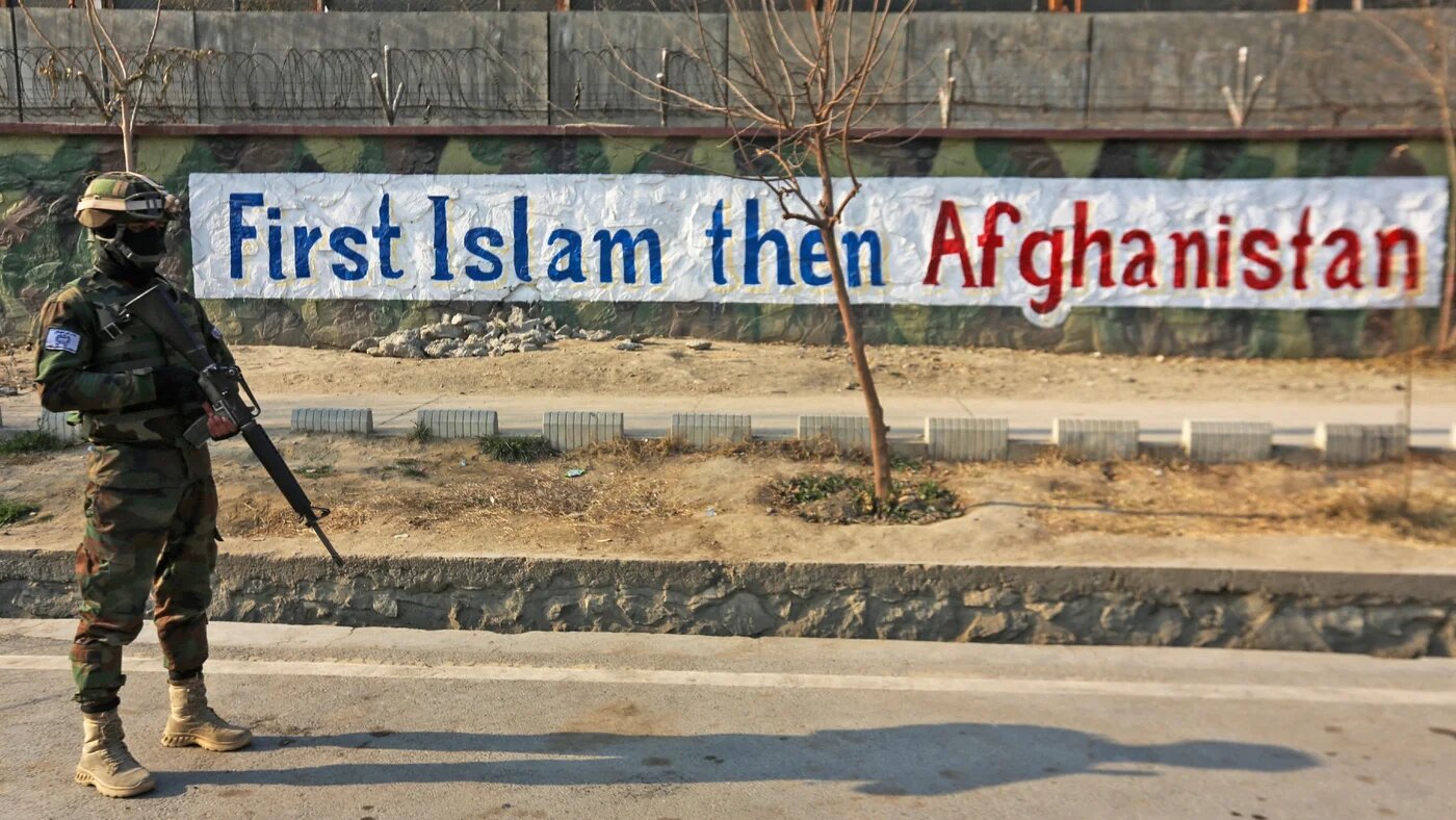 A Taliban fighter stands guard along a street in Kabul on 27 December (AFP)