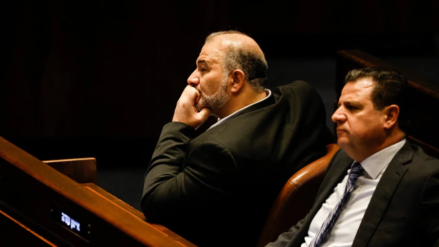 Lawmakers Mansour Abbas (L) and Ayman Odeh (R) attend a special session of the Knesset (Israel's Parliament), to approve and swear in a new right-wing government, in Jerusalem on 29 December 2022 (Amir Cohen/AFP)