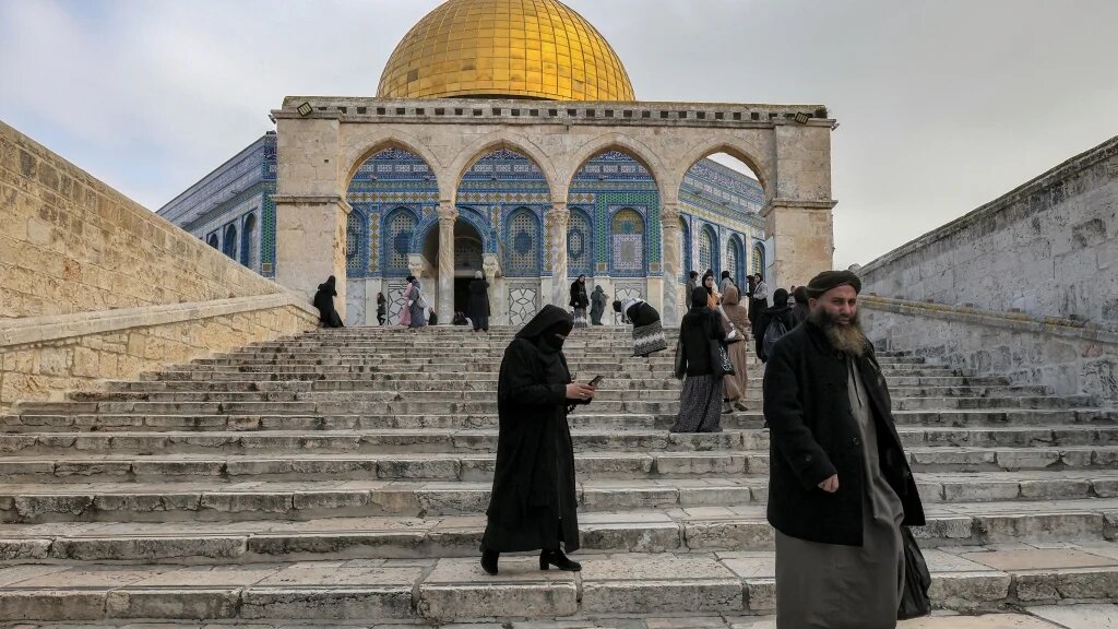 People descend steps as they walk away from the Dome of the Rock shrine at Al-Aqsa mosque compound (also known as the Temple Mount complex to Jews) in the old city of Jerusalem on January 3, 2023 (AFP)