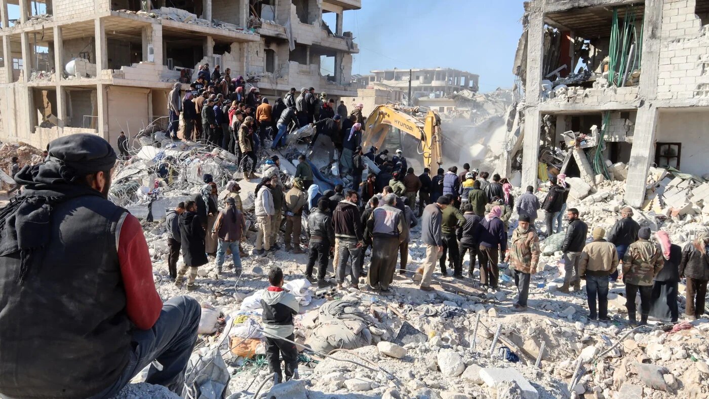 Rescue workers look for survivors amid the rubble of a building in the rebel-held town of Jindayris on February 9, 2023, three days after a deadly earthquake that hit Turkey and Syria (AFP)
