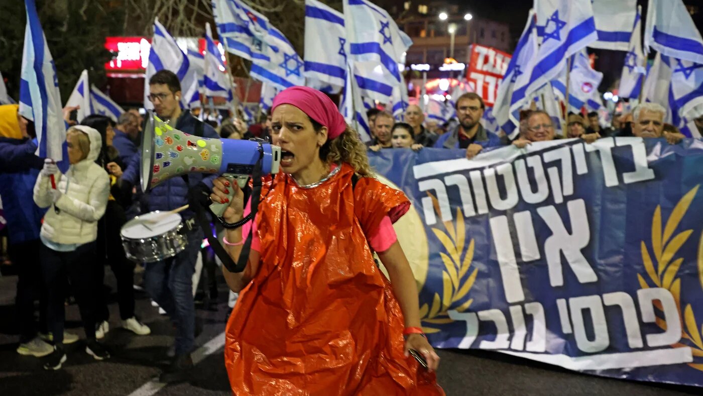 Protesters gather during a rally against the government's controversial judicial overhaul bill in Haifa on March 18, 2023 (AFP)