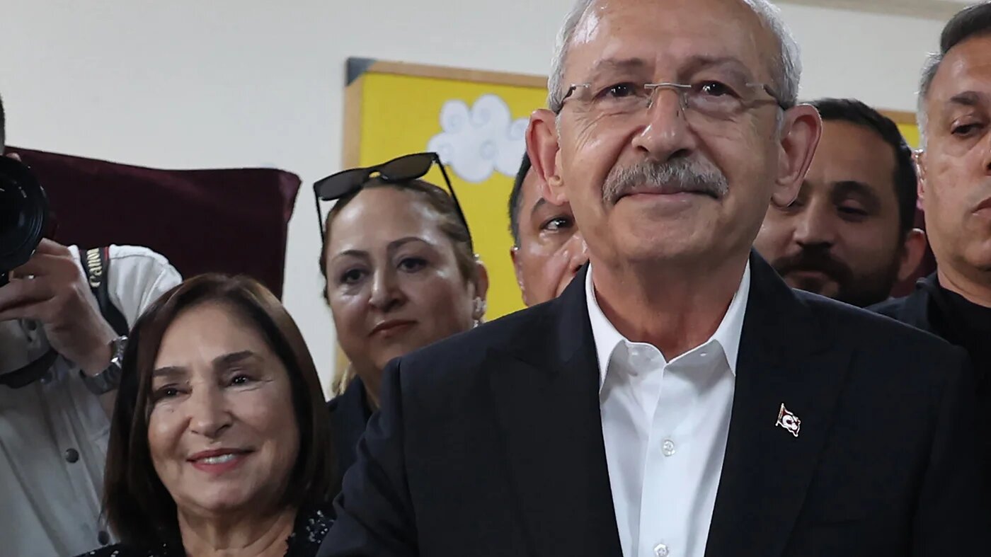 Kemal Kilicdaroglu (R) the 74-year-old leader of the Republican People's Party, or CHP, casts his vote next to his wife Selvi Kilicdaroglu (2L) at a polling station in Ankara on May 14, 2023 (AFP)