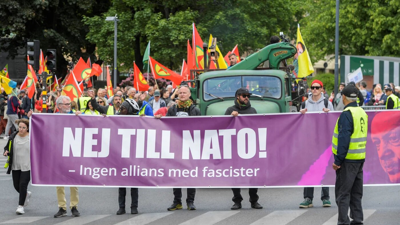 Activists of the "Alliance against NATO" network hold a banner reading "No to NATO! - No alliance with fascists" during a demonstration in Stockholm on 3 June (AFP)