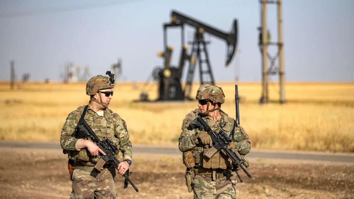 US troops patrol near an oil well in al-Qahtaniyah in Syria’s northeastern Hasakah province, close to the border with Turkey, on 14 June 2023 (Delil Souleiman / AFP)