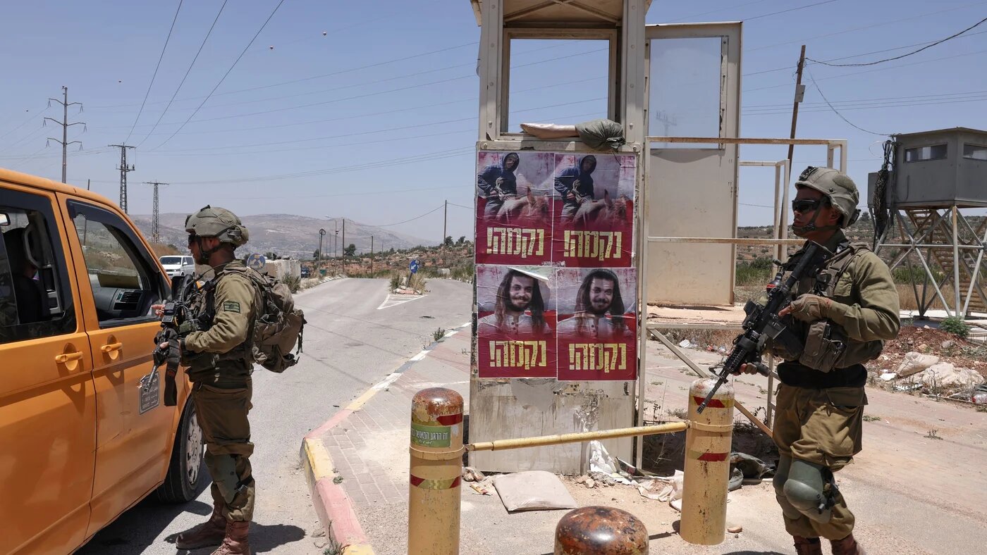Israeli soldiers stand guard near the settlement of Kfar Tapuach in the occupied West Bank, on 25 June 2023 (AFP)