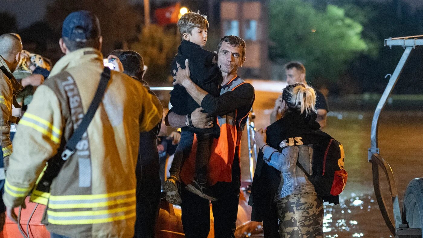 People are rescued and evacuated by boat during flooding in Kucukcekmece district in Istanbul on 5 September  2023 (AFP)