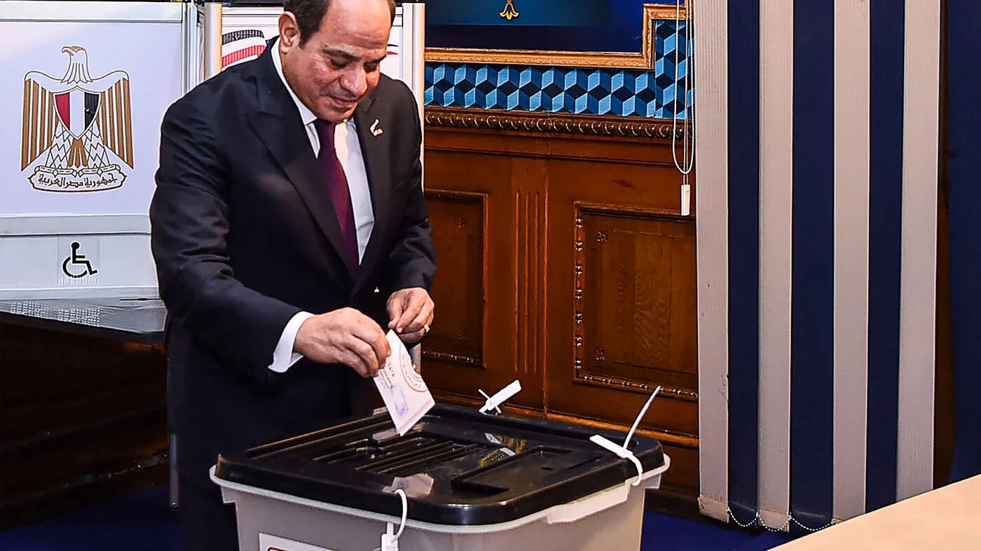 This handout picture released by the Egyptian Presidency on December 10, 2023, shows Egyptian president Abdel Fattah al-Sisi casting his vote in the presidential election at Mustafa Yousry Emmera School in Cairo (Egyptian Presidency/AFP)