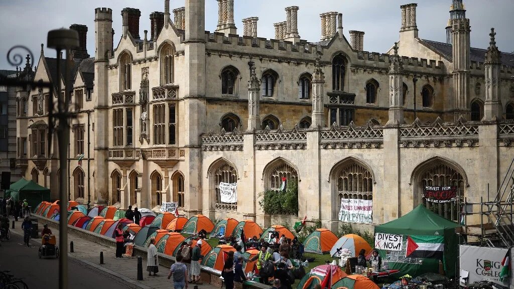 Students gather around their tents during a protest in support of Palestinian people, at Kings College at Cambridge University in Cambridge, eastern England on May 7, 2024