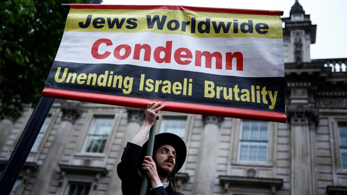 A member of the ultra-Orthodox Jewish community holds a placard outside Downing Street, central London, on 28 May 2024, during an "End the genocide" rally calling for a ceasefire in Gaza (Benjamin Cremel/AFP)
