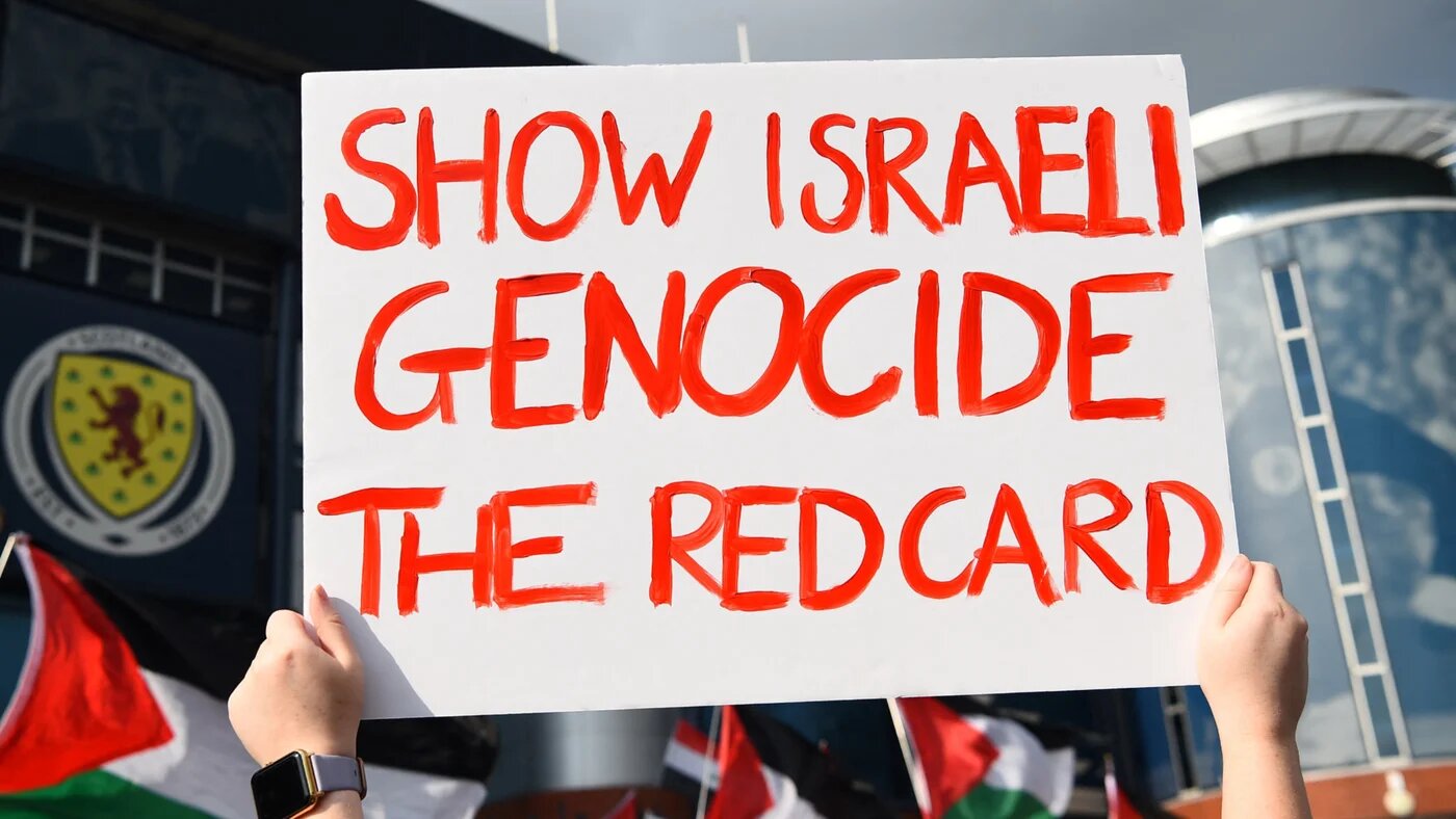 A Pro-palestinian supporter holds a placard as she demonstrates outside Hampden Park stadium, in Glasgow, Scotland, on 31 May 2024 prior to the UEFA Women's Euro 2025 League B Group 2 qualifying football match between Scotland and Israel (Andy Buchanan/AFP)