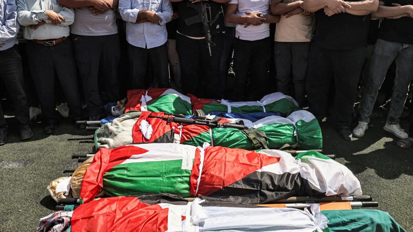 Mourners pray by the bodies of four men who were killed by Israeli forces during their funeral in the al-Far'a refugee camp near Tubas in the occupied West Bank on 29 August 2024 (AFP/Zain Jaafar)