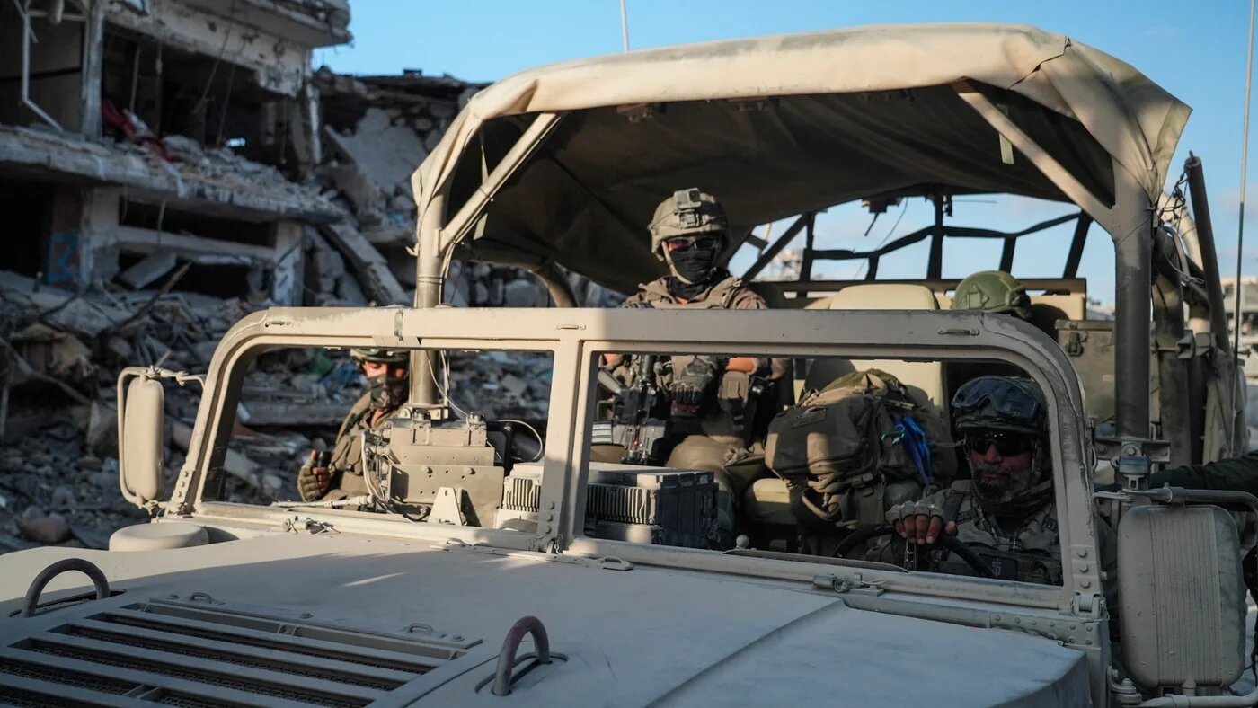 Israeli soldiers drive past destroyed buildings in Rafah in the Gaza Strip on 13 September 2024 (AFP/Sharon Aronowicz)