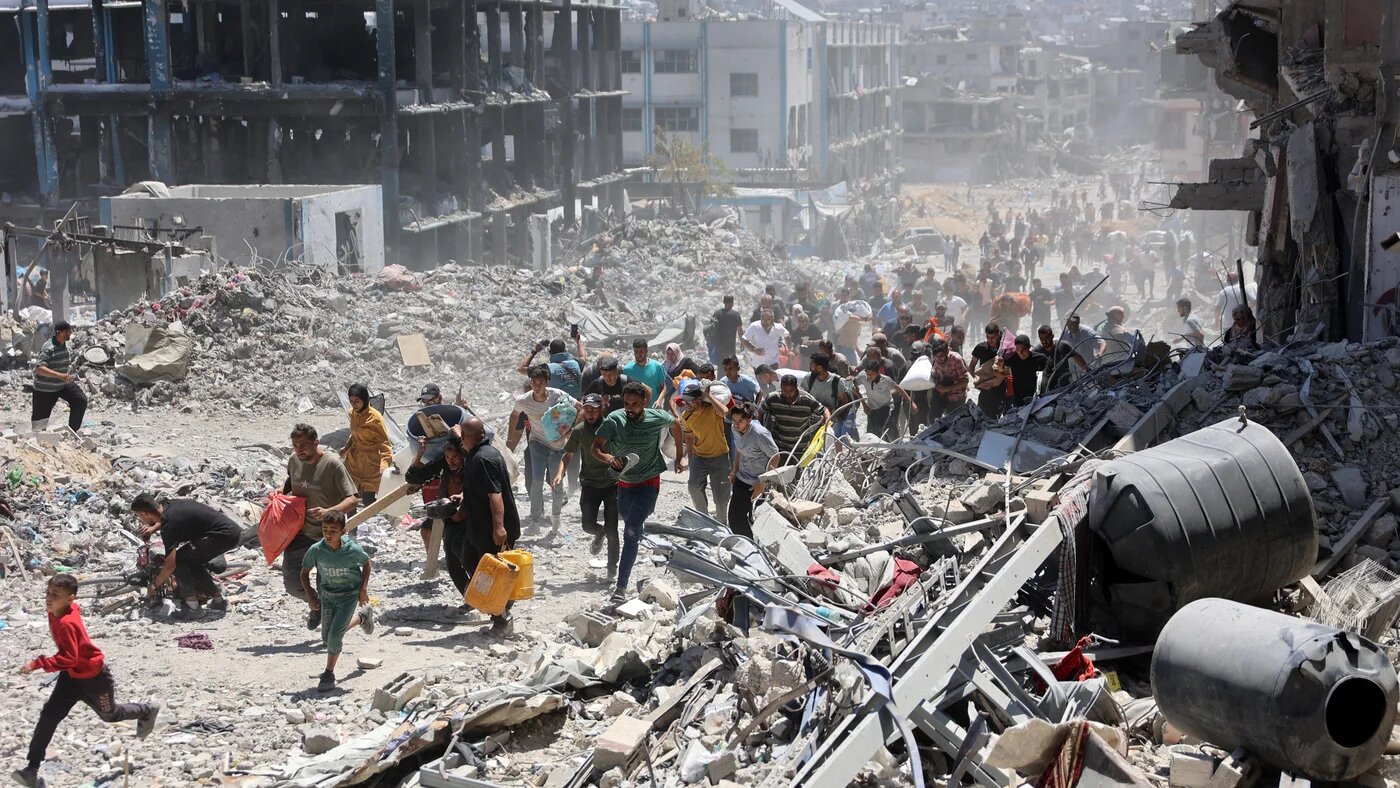 Palestinians in northern Gaza run for cover after an Israeli strike hit a school on 30 May 2024 (AFP/Omar al-Qattaa)