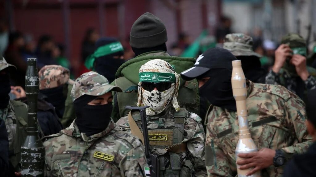 Palestinian fighters attend a funeral in the war-devastated Bureij refugee camp in the central Gaza Strip on 7 February (AFP)