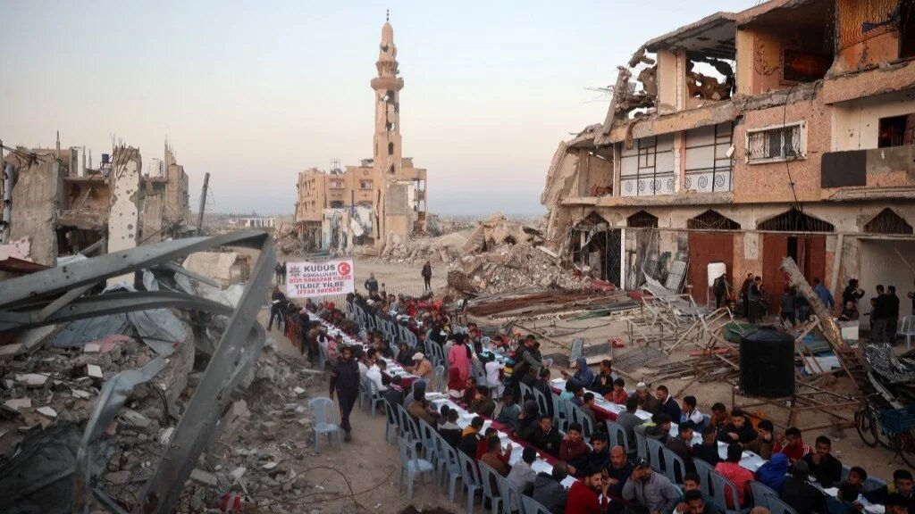  Palestinians gathered for a communal iftar fast-breaking meal, amid the devastation in the Nuseirat refugee camp in the central Gaza Strip, during the Muslim holy fasting month of Ramadan on March 14, 2025