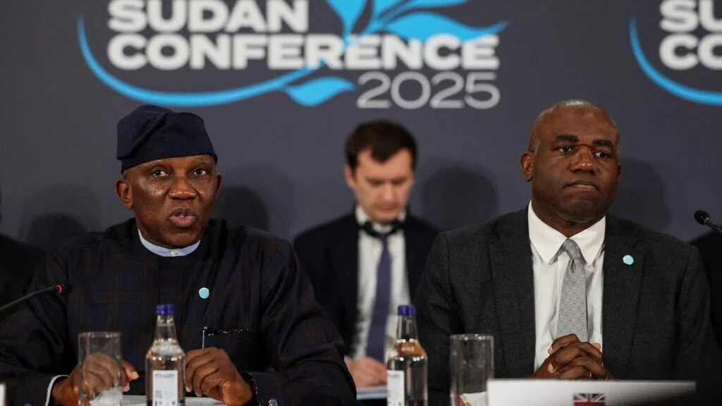 Britain's Foreign Secretary David Lammy (right) and Bankole Adeoye (left), the African Union's commissioner for political affairs, peace and security, attend the London Sudan Conference 2025 at Lancaster House on 15 April (AFP)